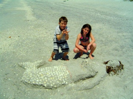 A couple of creative kids decorate the sands of Don Pedro Island with a sand mermaid.