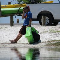Kayaking Anna Maria with Native Rentals Shawn Duytschaver of Native Rental is as much at home conducting business on the water via cell phone as he is from his shop at the Island Shopping Center in Holmes Beach. Here he takes a call while loading kayaks onto the trailer after being out on the water.