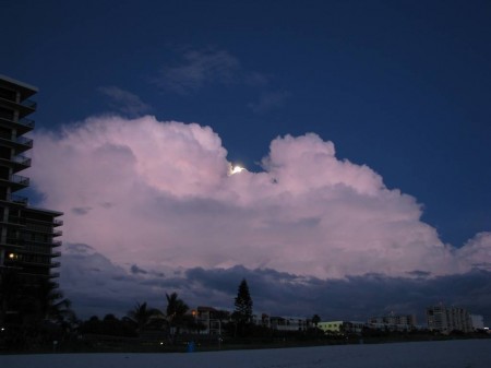 IMG_4875 The nearly full moon peeks from behind the marauding cloud bank to illuminate the beach and to work its magic on the tides.