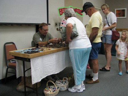IMG_4948 Collector Bill Blazek shows off his magnificent collection of sea-beans at last year's Symposium. Even kids love 'em.