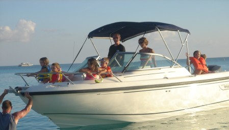 children-boat-safety Children wearing life jackets on a boat.