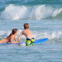 children playing in the surf on anna maria island
